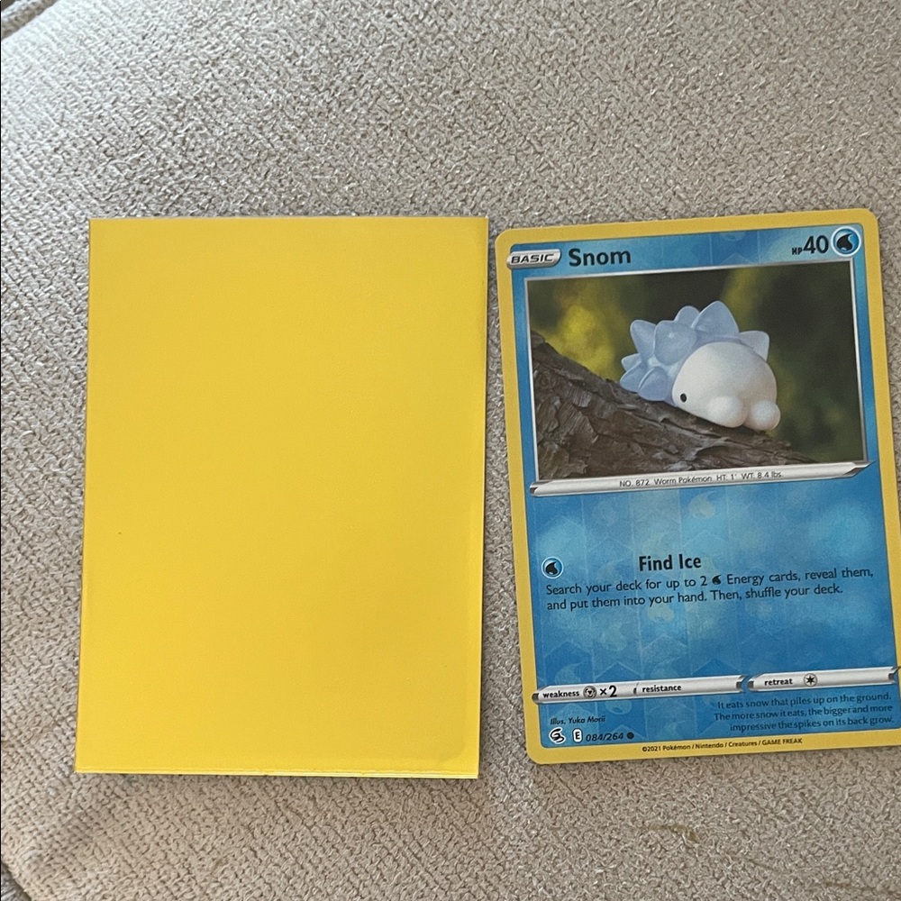 Snom Pokémon Card with Yellow Sleeve